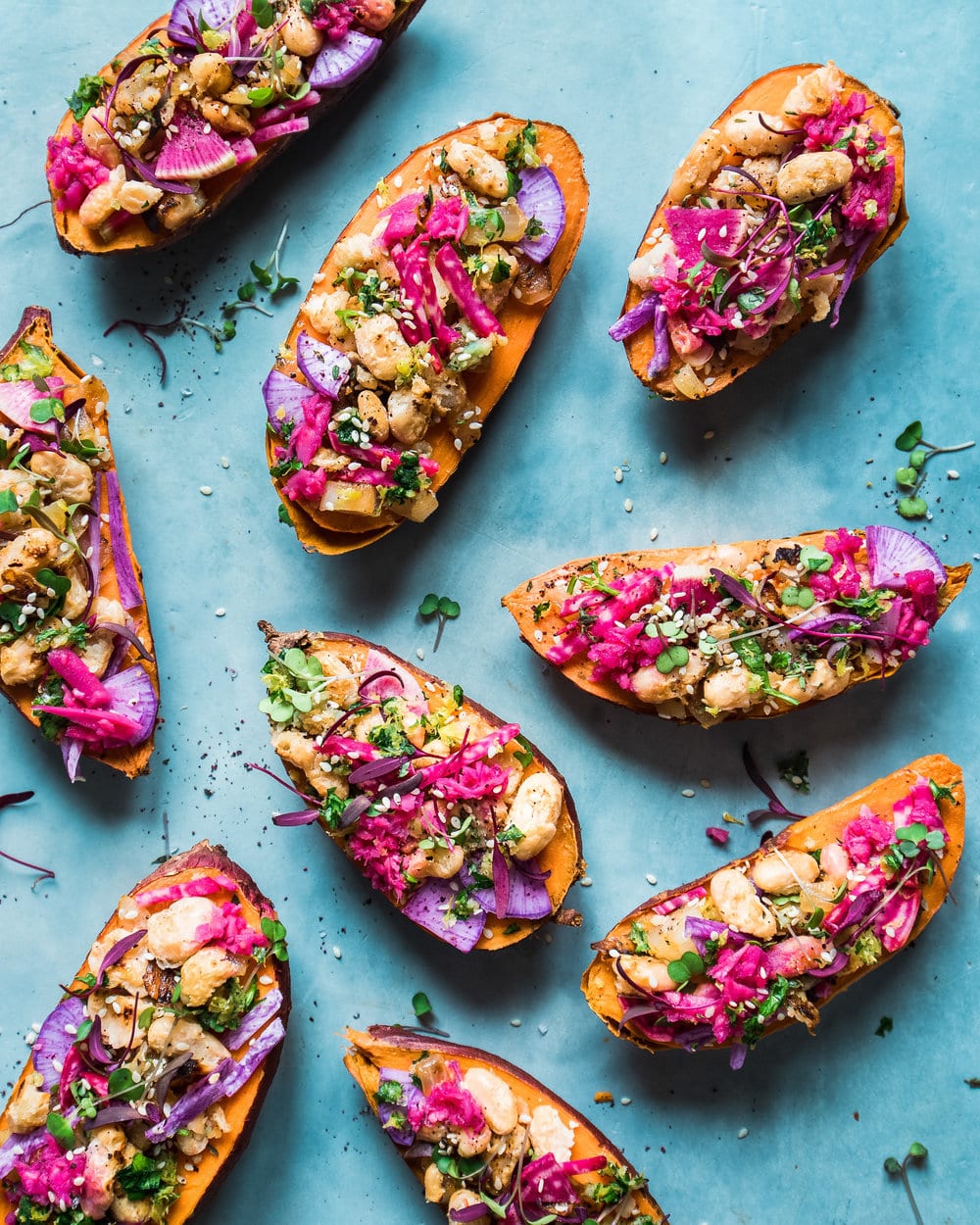 9 halves of stuffed sweet potatoes on a blue table.