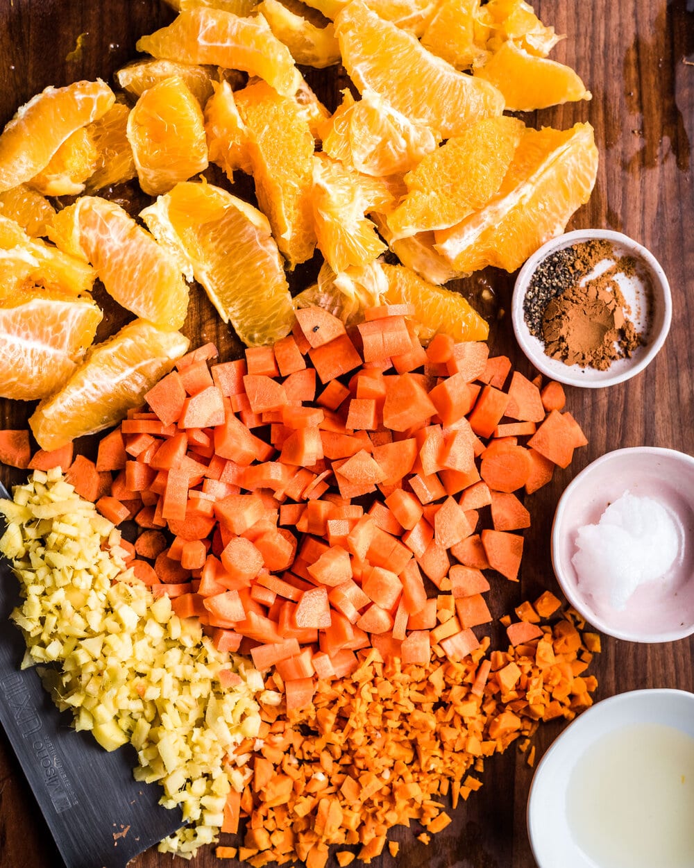 Turmeric tonic ingredients on a wood cutting board.