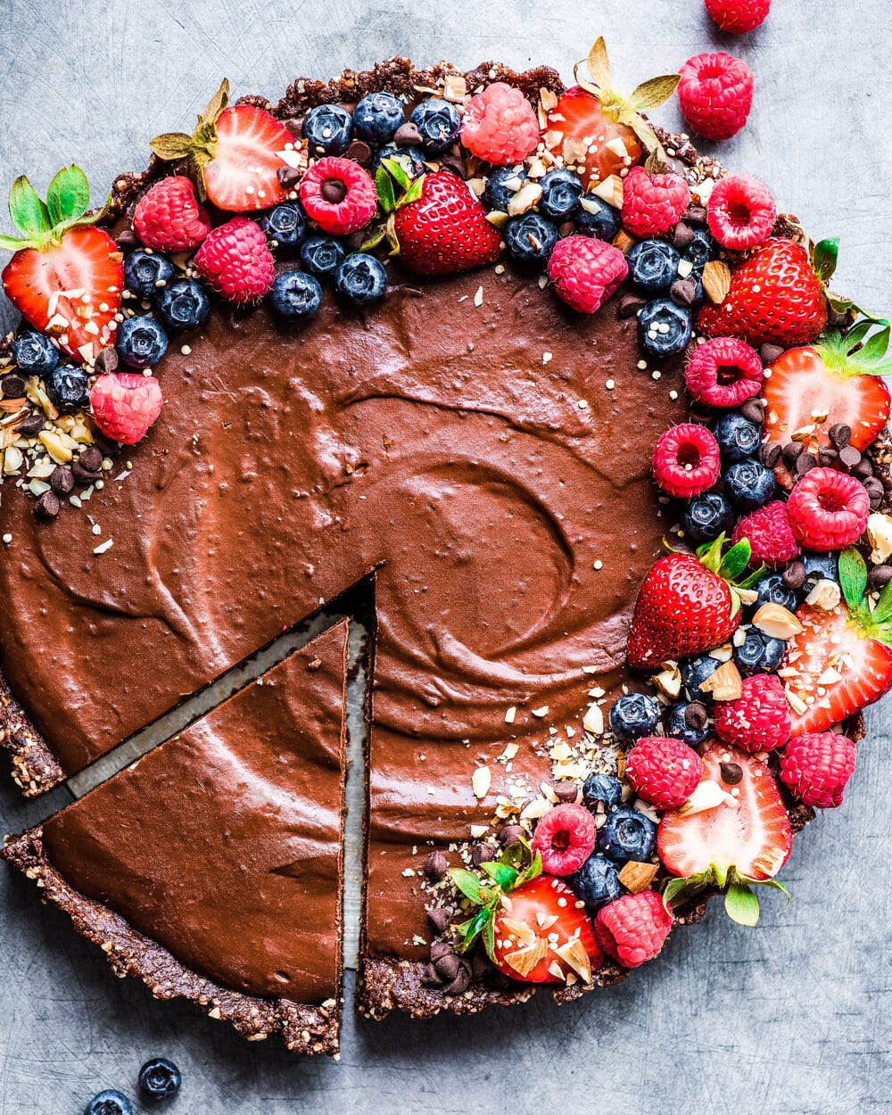 Vegan salted chocolate cream tart with berries.