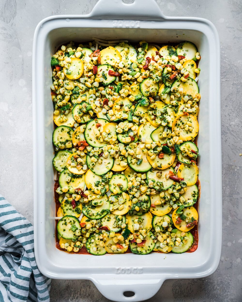 another layer of zucchini, corn, jalapeno, basil mixture in casserole pan