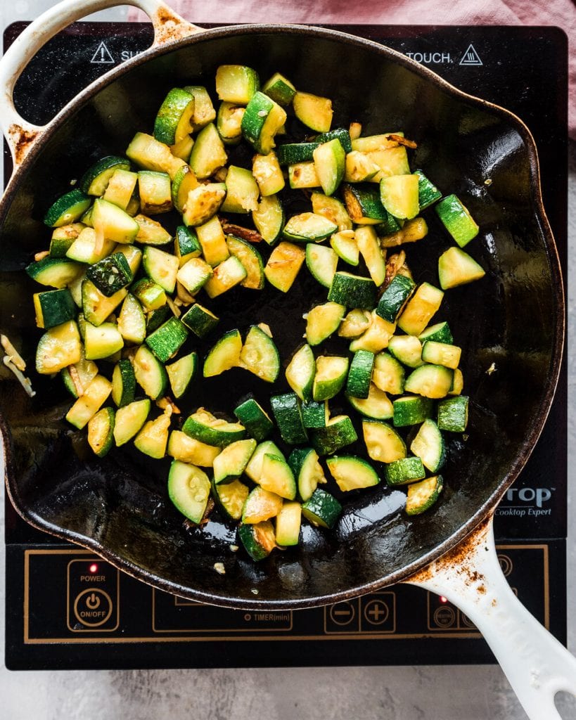 zucchini getting browned in a skillet