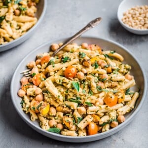 Bowl of creamy vegan zucchini pesto pasta with fork in it