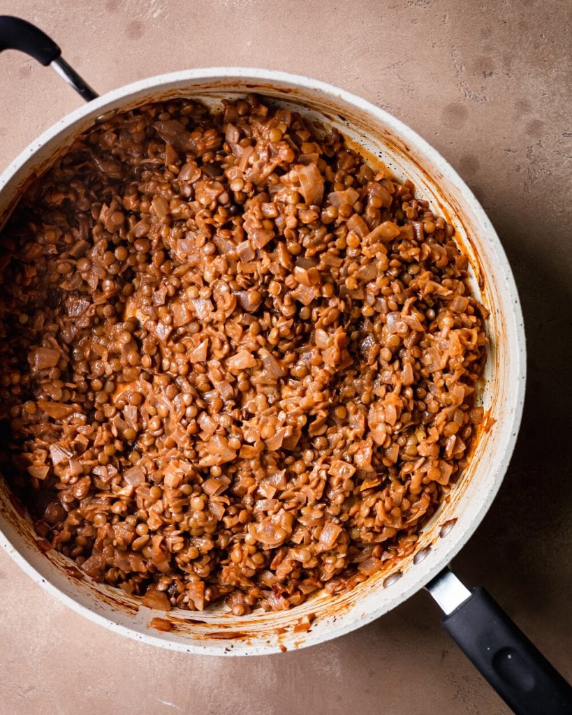 simmered lentils in saute pan with tahini, miso, and balsamic vinegar