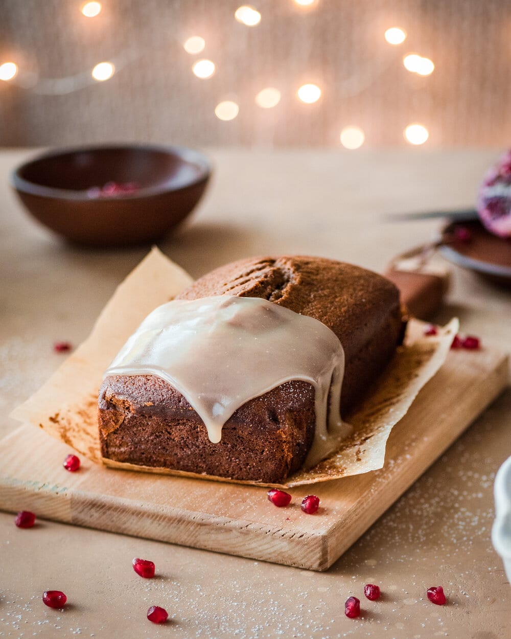 Vanilla cream sauce dripping off gingerbread loaf.