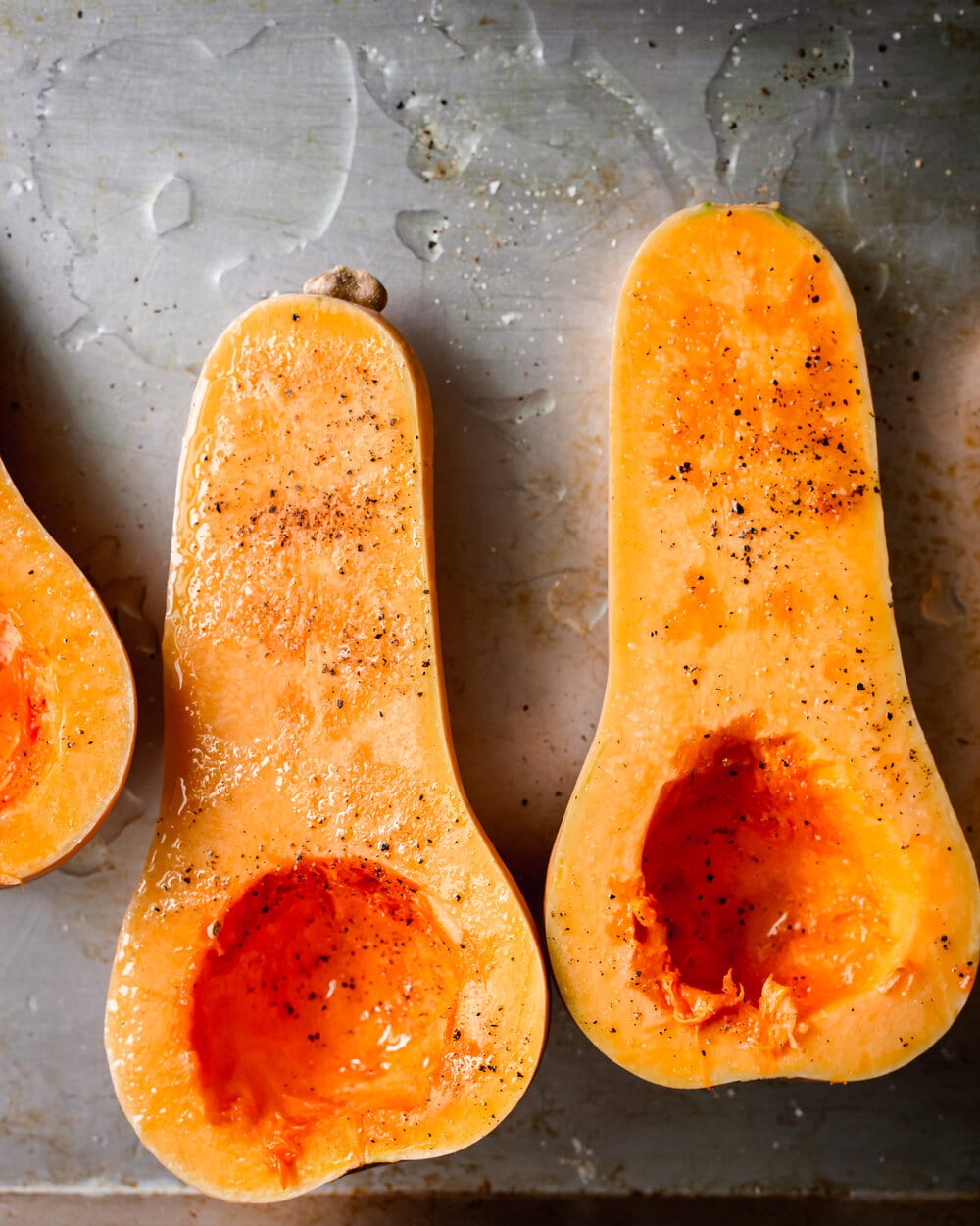 squash on baking tray with salt and pepper.