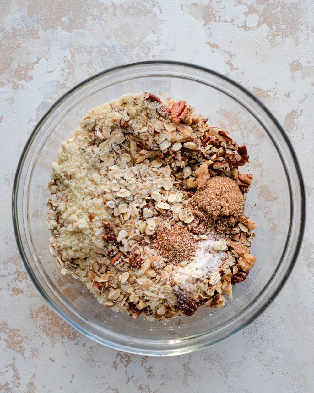Crumble topping ingredients all together in a glass bowl.