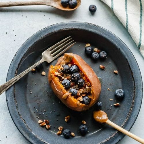 sweet potato stuffed with blueberries on plate