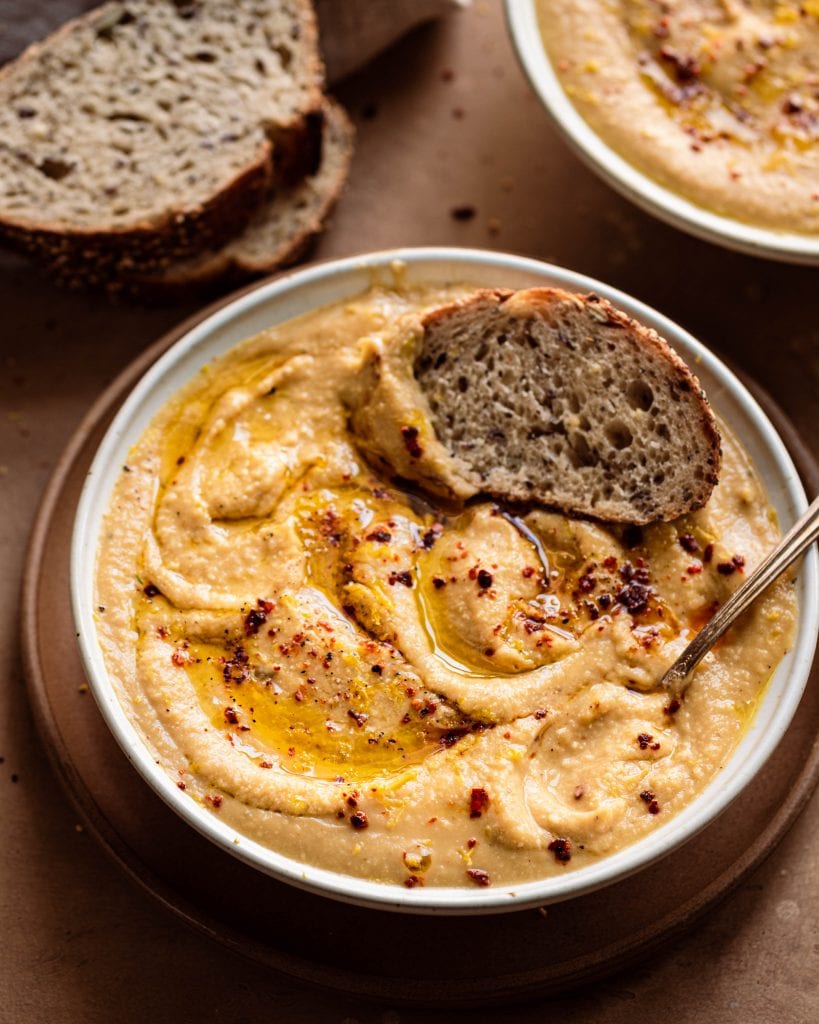 creamy vegan instant pot cauliflower soup closeup in a bowl with bread