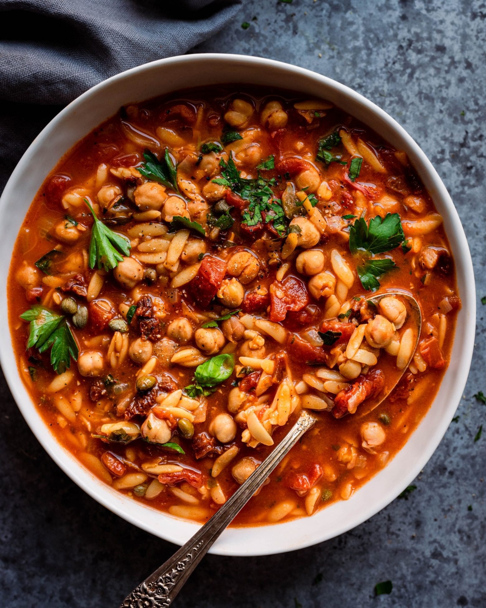 Instant Pot Chickpea Orzo Soup in white bowl with spoon