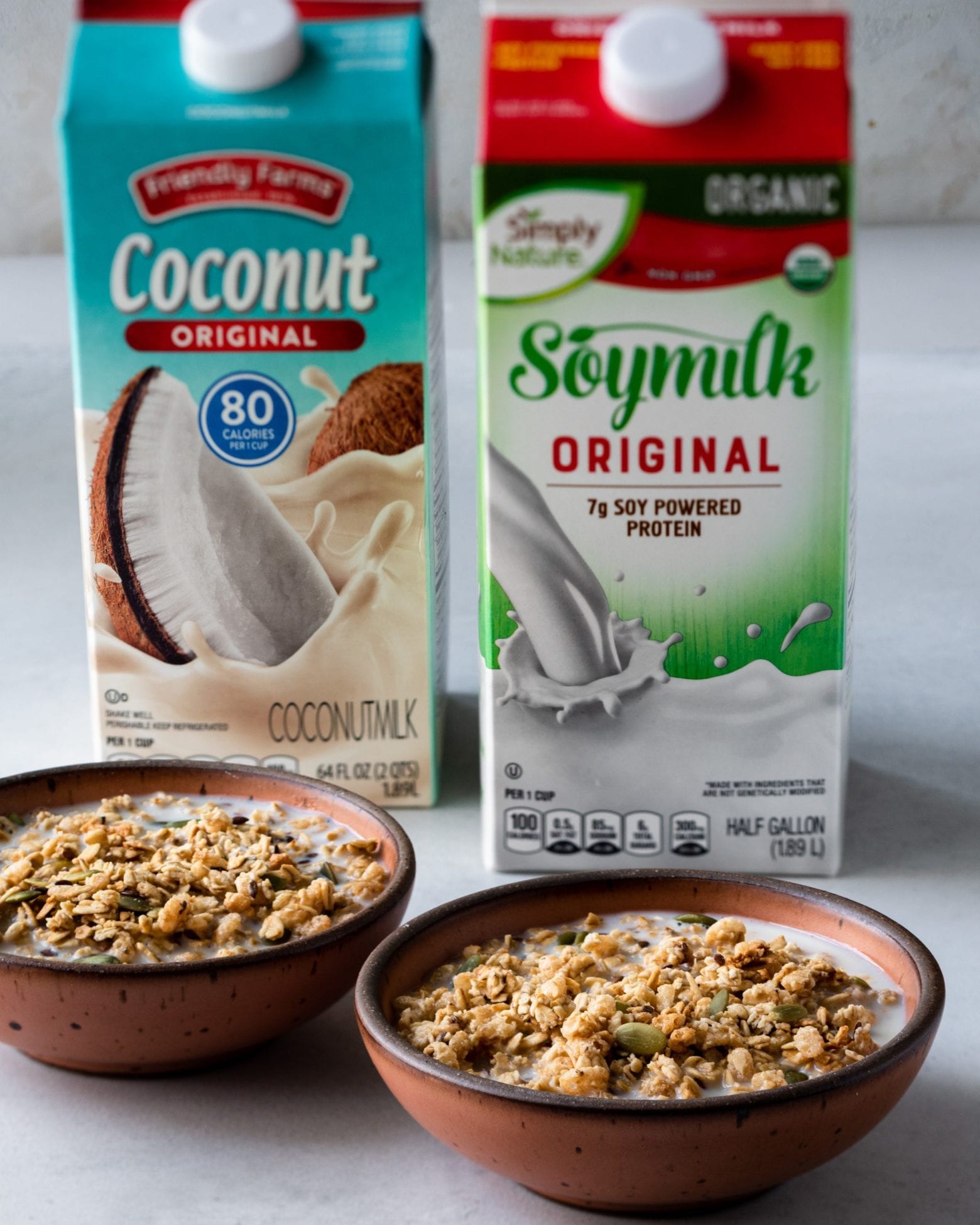 vegan alternative milks with bowls of granola
