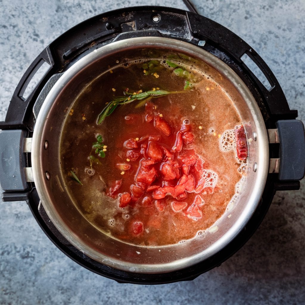 add tomatoes and herbs to the instant pot