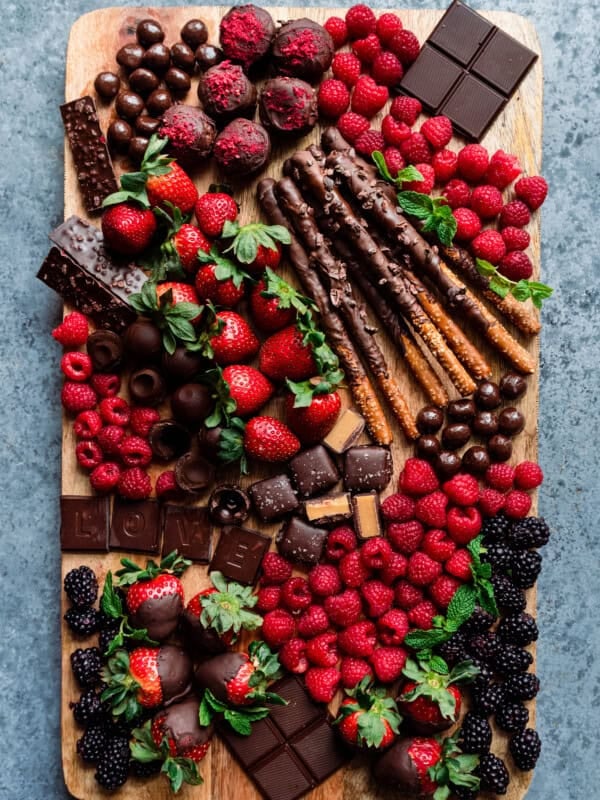 dessert board with berries, chocolates, and snacks