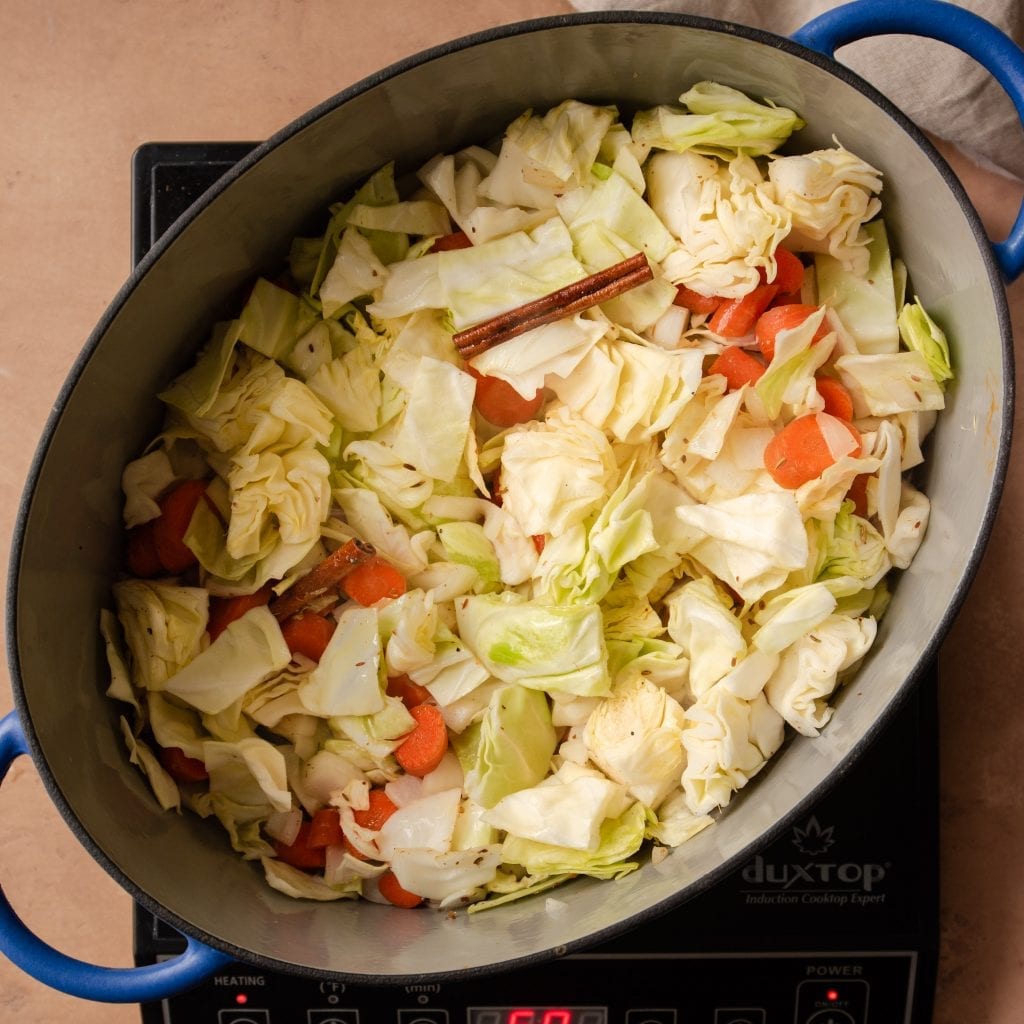 sauteing cabbage and carrots in a dutch oven