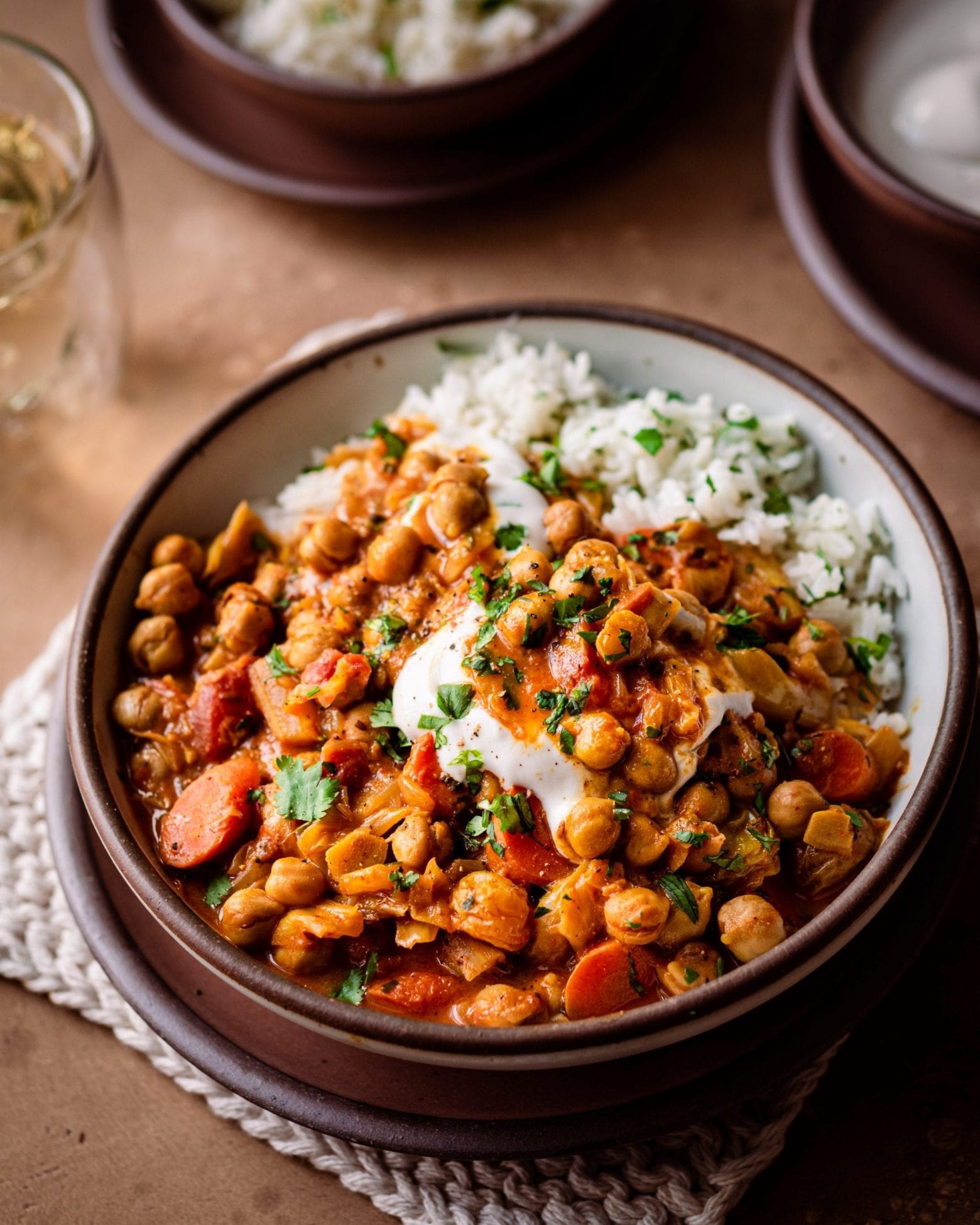 braised indian chickpea stew in bowl with yogurt