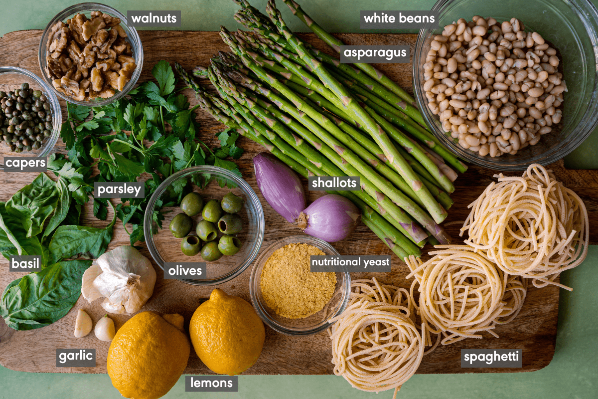 Lemon Asparagus Pasta ingredients in various small bowls on a wooden cutting board.