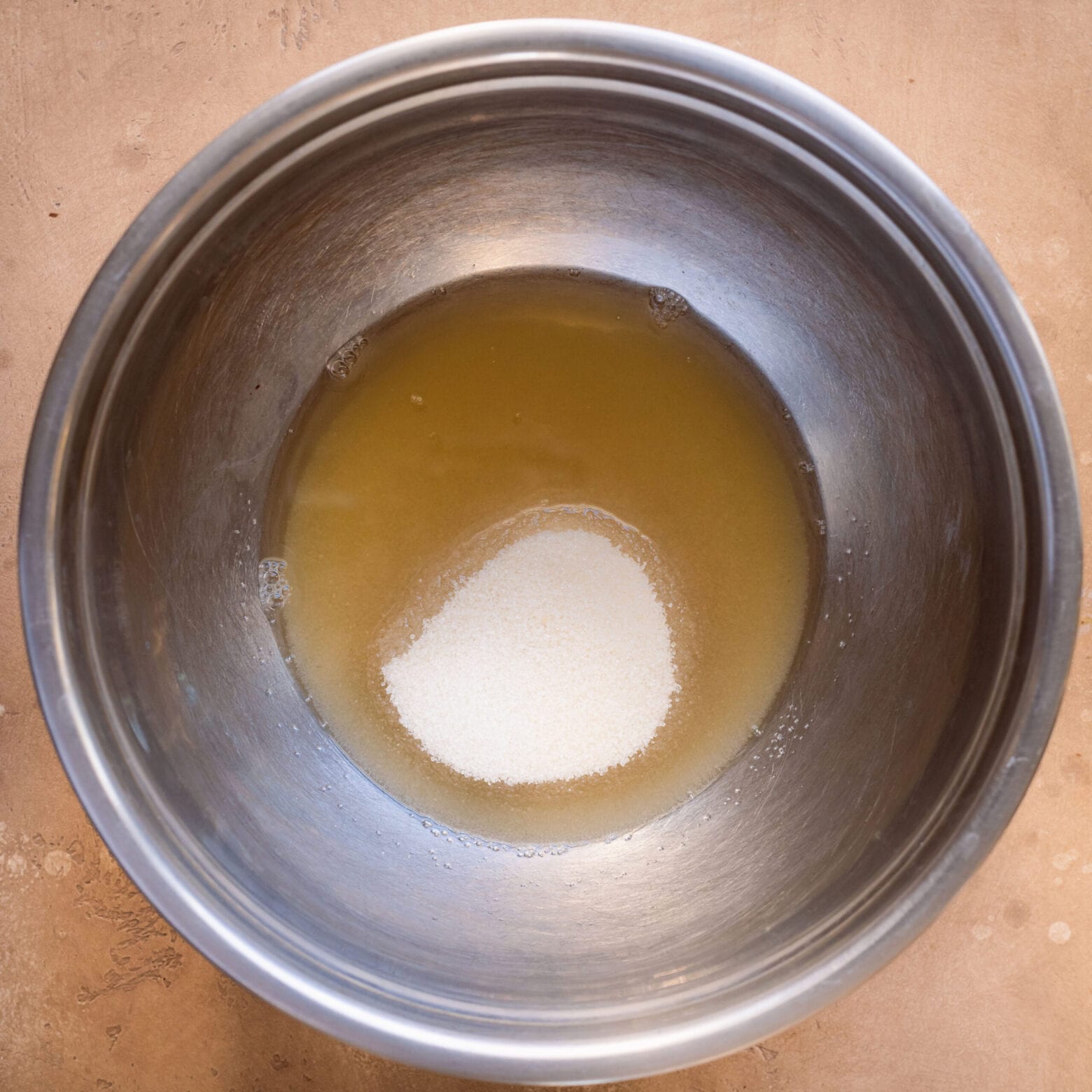 mixing bowl of aquafaba and sugar