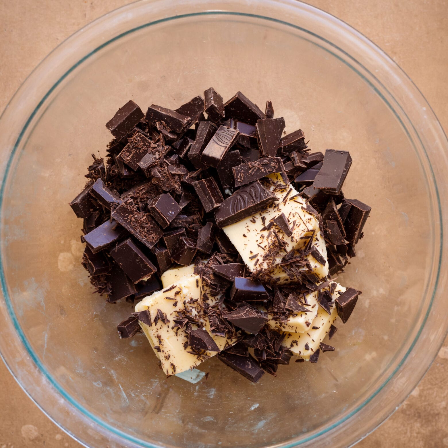 glass bowl of chopped dark chocolate and cubed butter