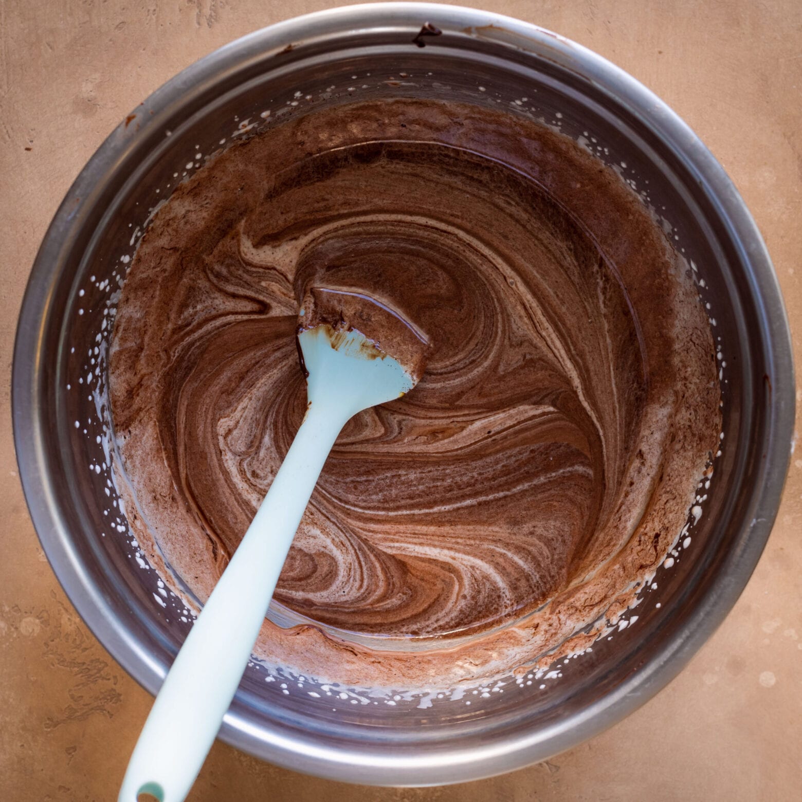 swirly chocolate mixture in a bowl with spatula