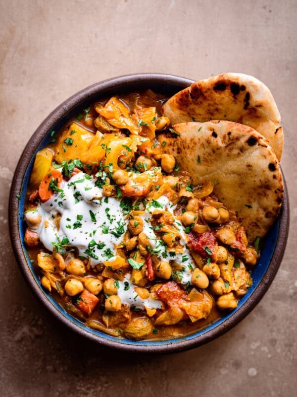 chickpea stew in a bowl with warm naan bread