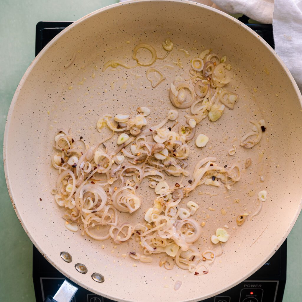 sauteing shallots, garlic and red pepper flakes in a frying pan