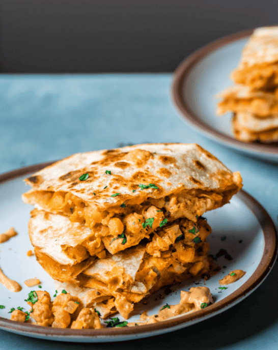 Buffalo chickpea quesadillas stacked on a plate.