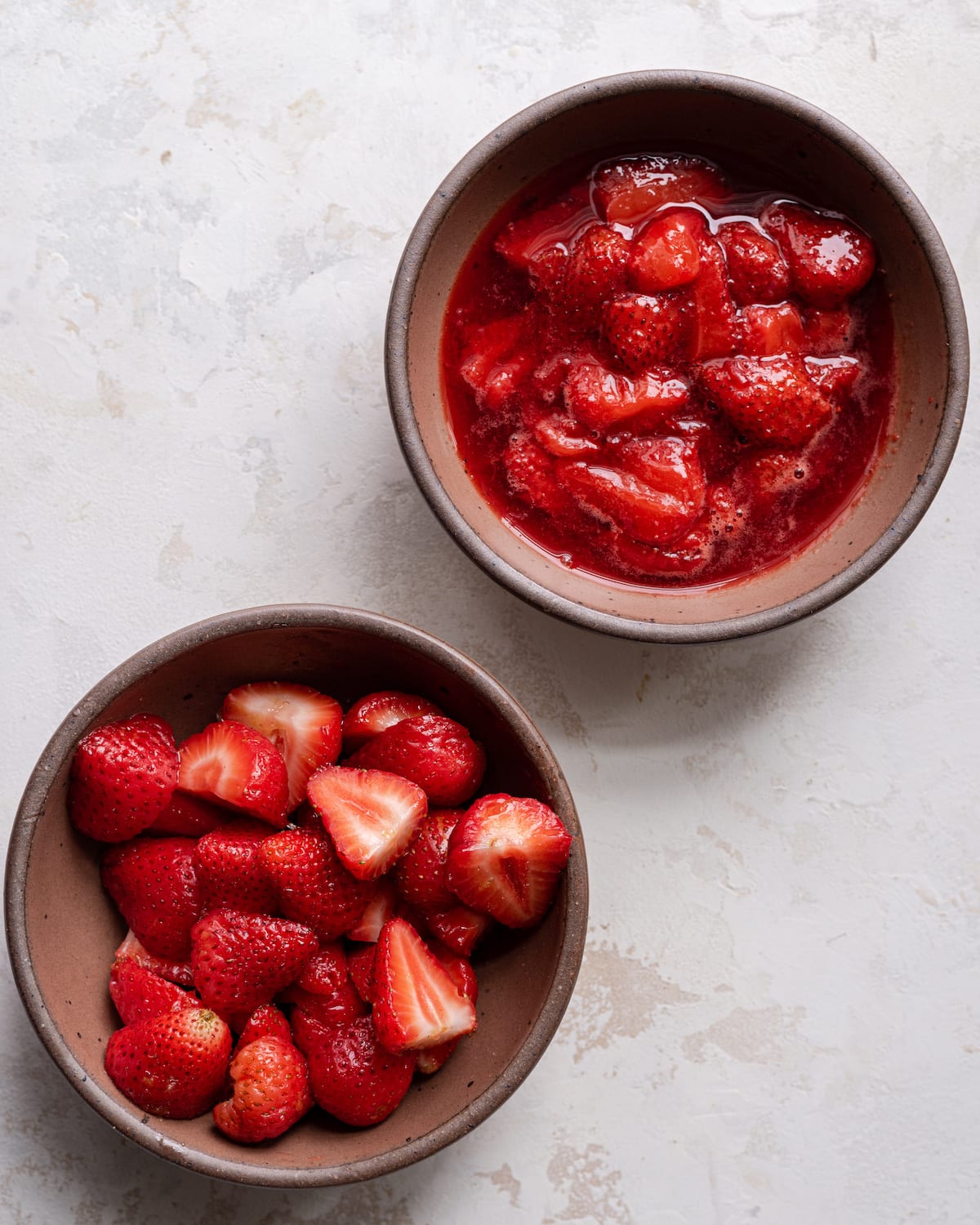 two bowls, one with strawberries, one with strawberry compote