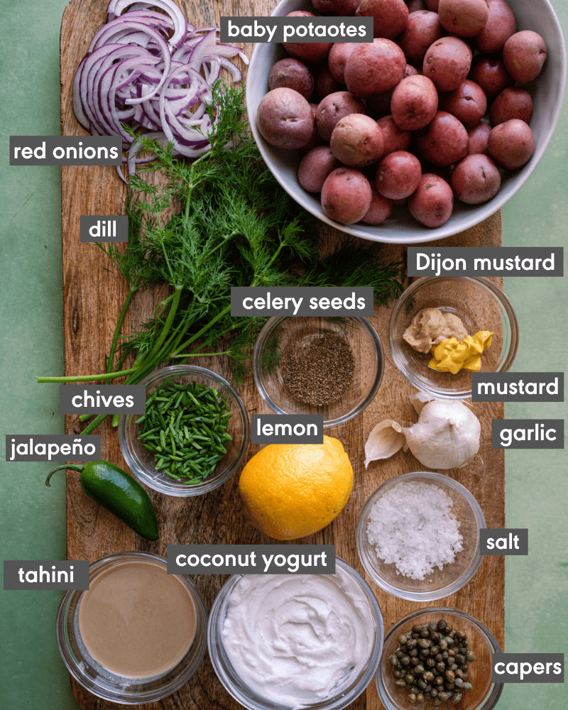 flatlay of ingredients for vegan potato salad with ingredients labeled