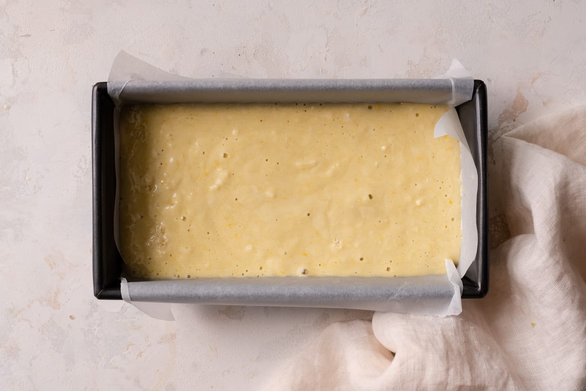 lemon cake batter in lined loaf pan