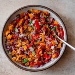pico de gallo in a white bowl with a spoon