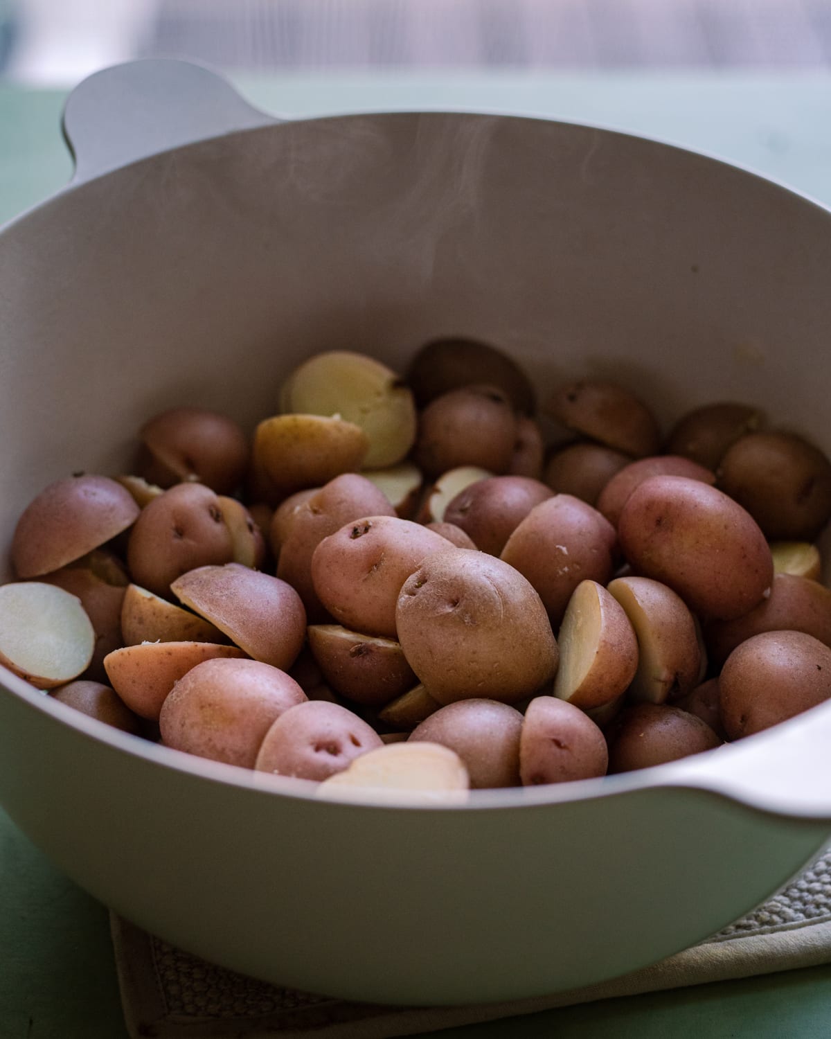 baby red potatoes steaming in a colander