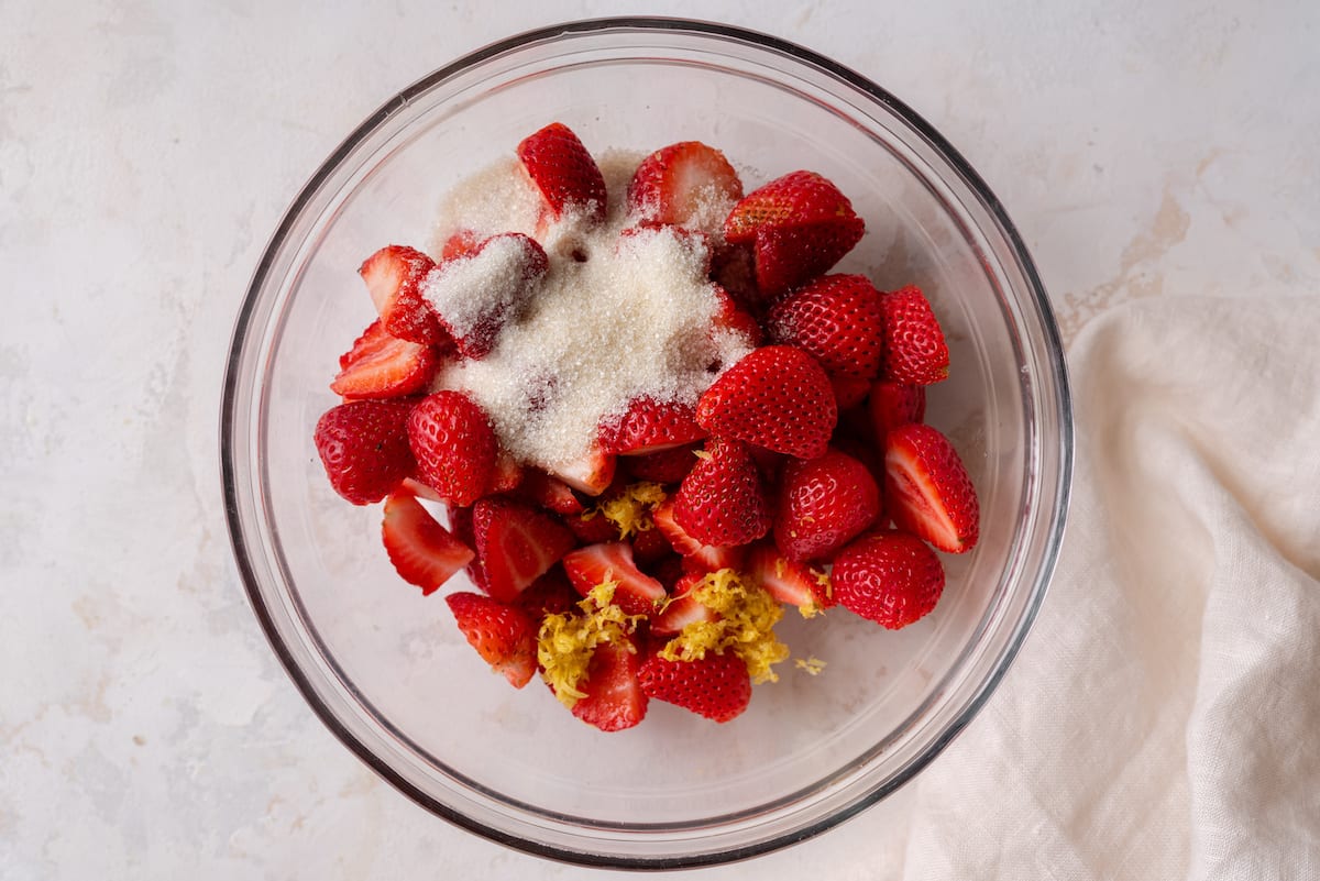 bowl of strawberries with lemon zest and sugar