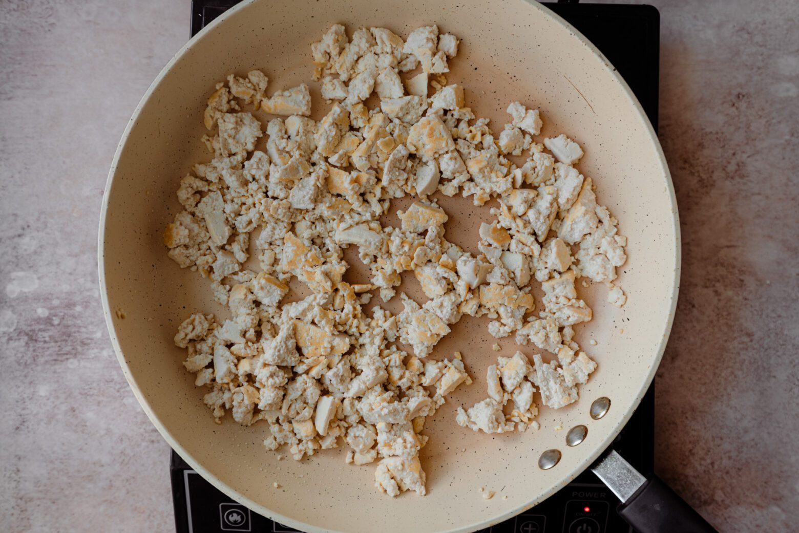 lightly golden tofu scramble in saute pan