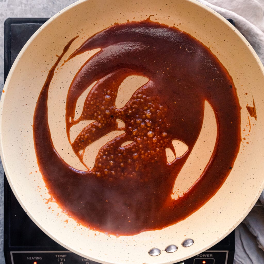 cooking barbecue sauce in skillet