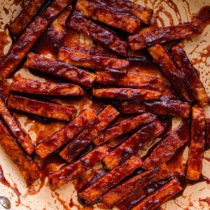 closeup photo of barbecue glazed tempeh in frying pan.