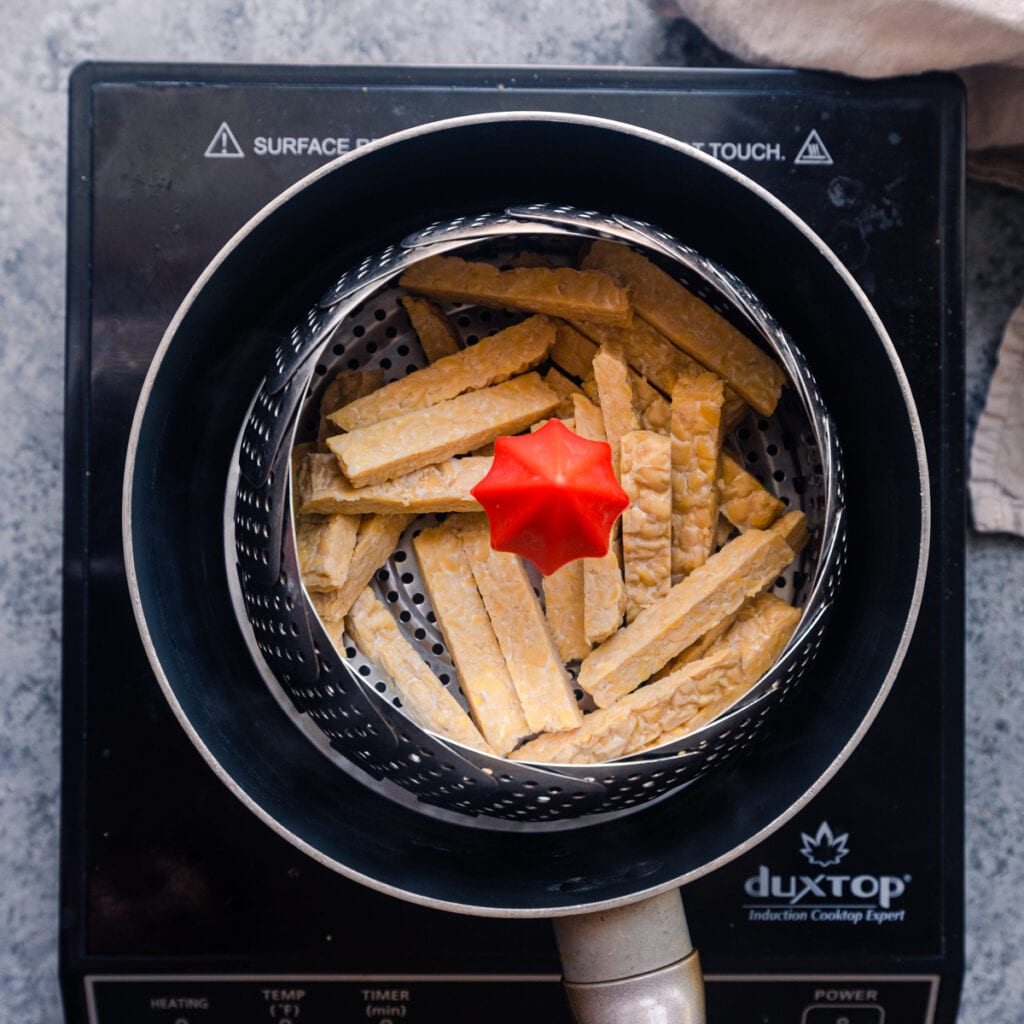 tempeh strips in steamer basket