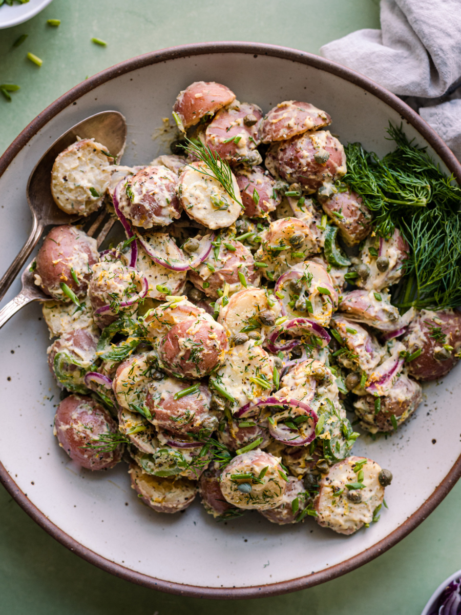 herbed vegan potato salad in a large blue bowl.