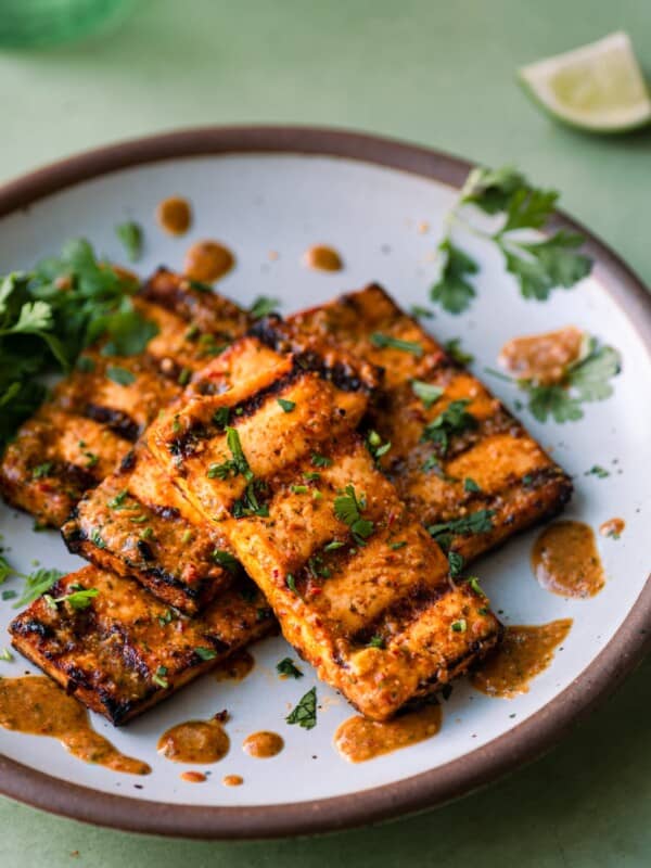 citrus-cilantro grilled tofu slabs on a white plate