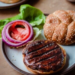 meaty grilled portobello mushroom burger with lettuce, tomato, and onion