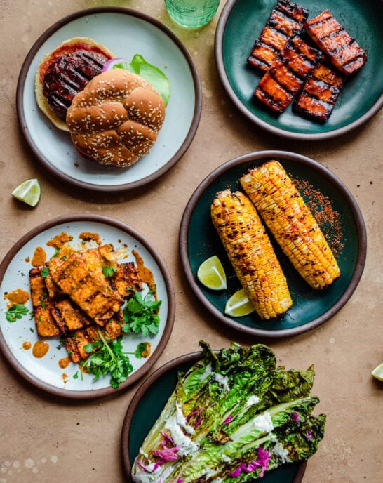 spread of vegan grilled food on a brown surface