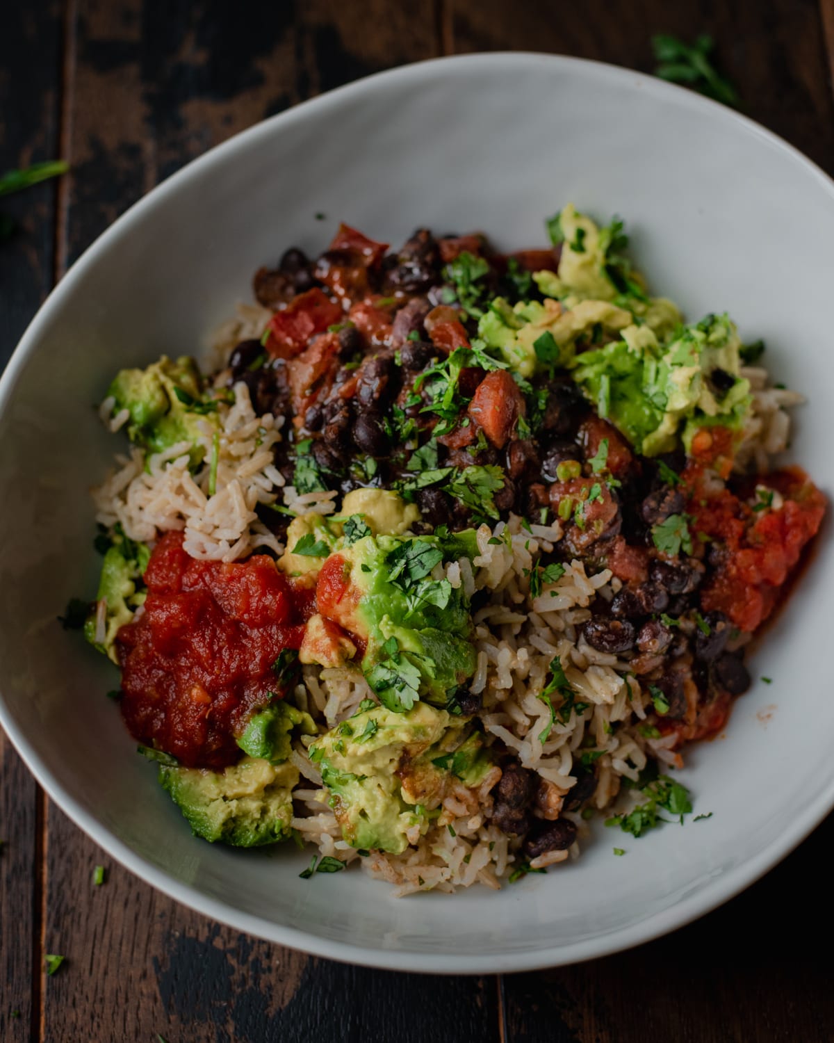 vegan burrito bowl with avocado black beans and salsa