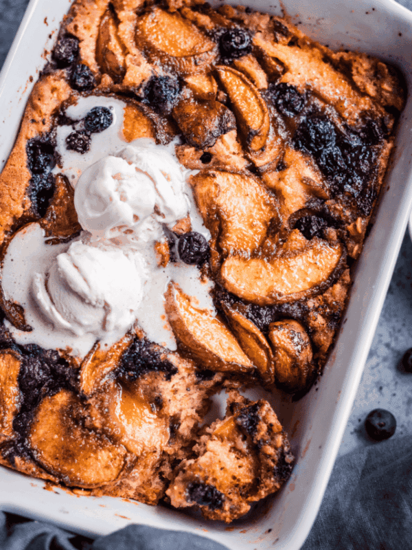 vegan brown butter peach cobbler in a baking dish.