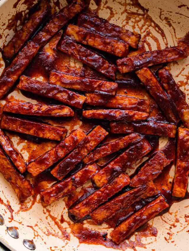 closeup photo of barbecue glazed tempeh in frying pan.