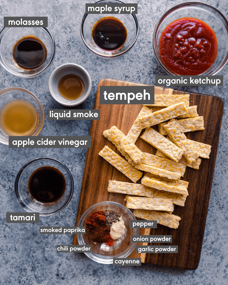 flatlay of ingredients for BBQ tempeh on blue board with ingredient names