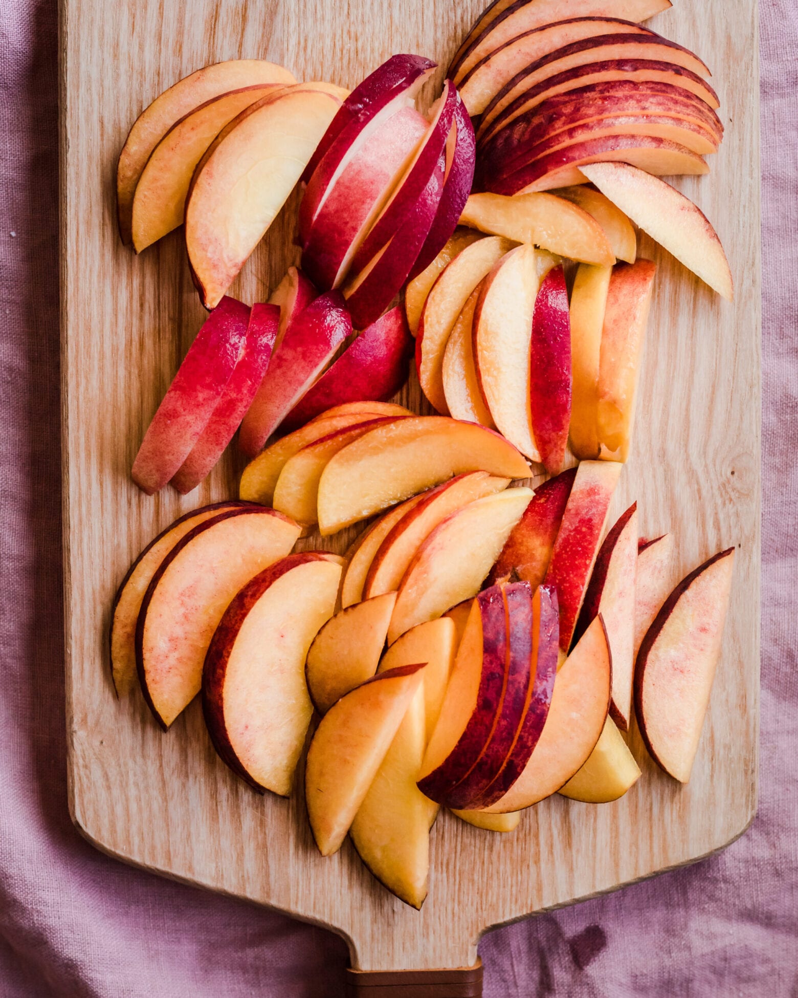 sliced peaches on cutting board