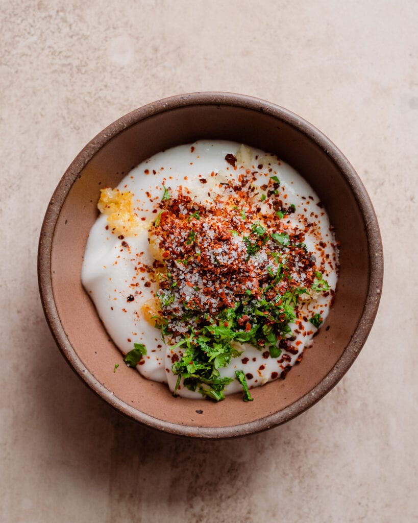 spices and herbs in bowl of yogurt