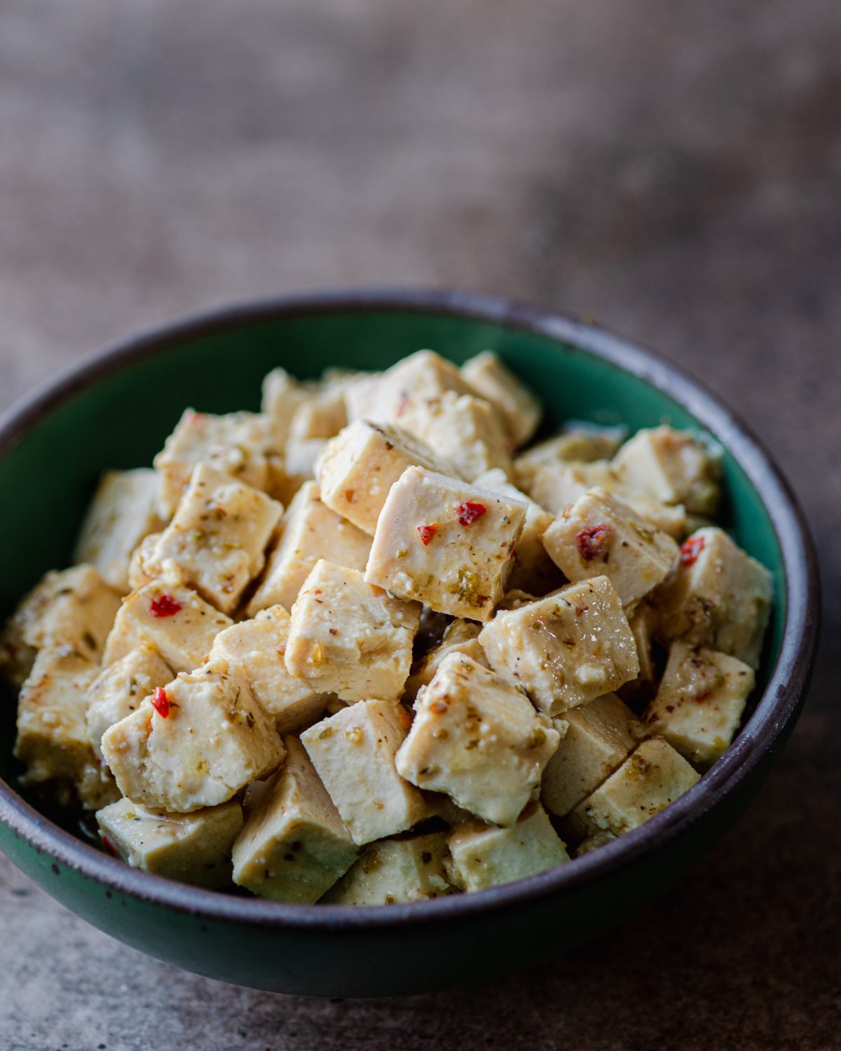 vegan feta made from tofu in a green bowl