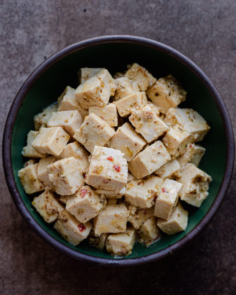 vegan feta made from tofu in a green bowl