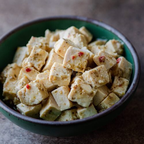 tofu feta in green bowl.