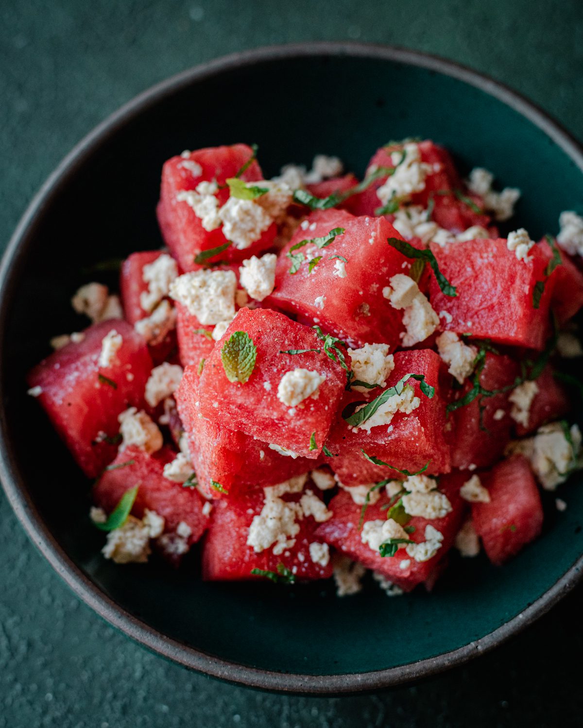watermelon salad with vegan feta in a bowl.