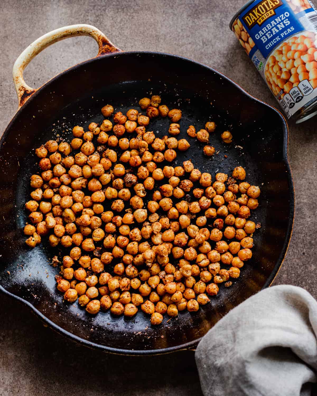 spiced chickpeas in pan with chickpea pan on the side